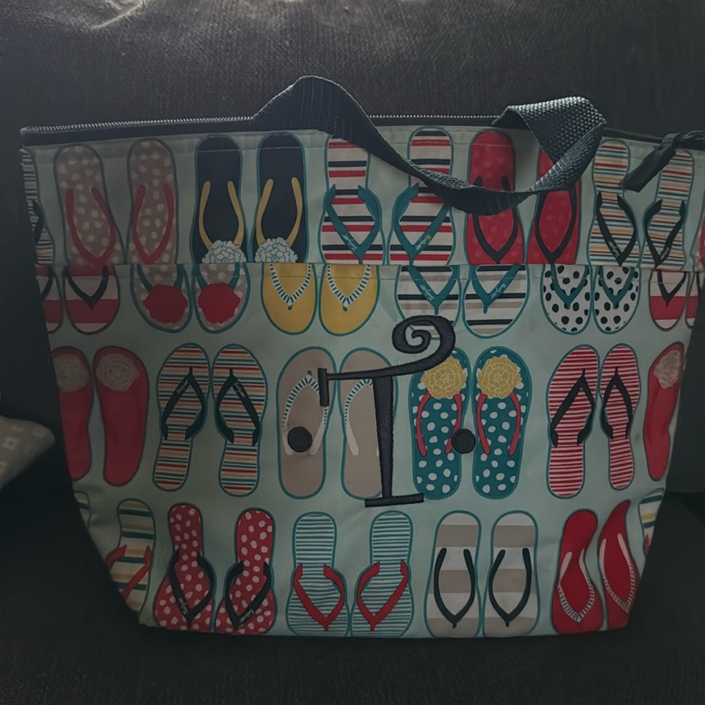 Thirty one flip flop lunch bag with the letter T on it.